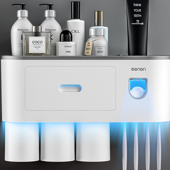 Wall mounted toothbrush holder with an automatic toothpaste dispenser and three rinse cups