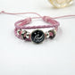 Pink braided cord bracelet with a mountain charm on the round center piece