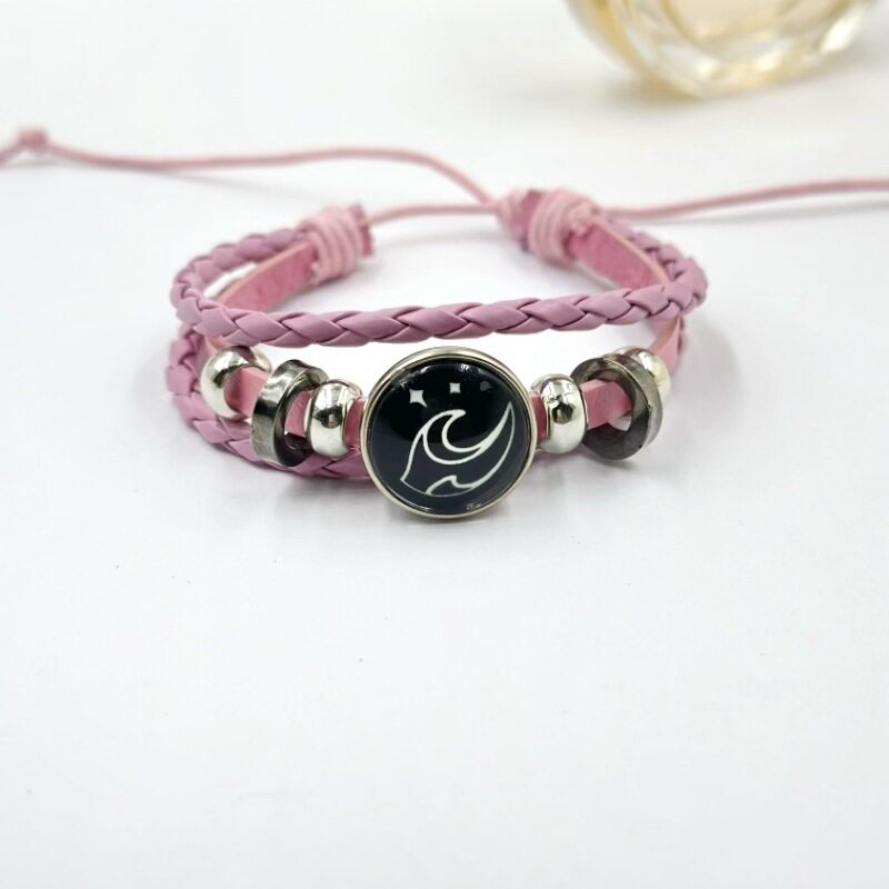 Pink braided cord bracelet with a mountain charm on the round center piece