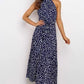 Navy polka dot halter neck sleeveless tiered swing maxi dress worn by a model
