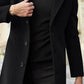 Man in a black single-breasted mid-length coat with notch lapel holding a bag on a city street, size XS option