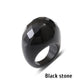 Black stone ring with a faceted geometric face on a white background