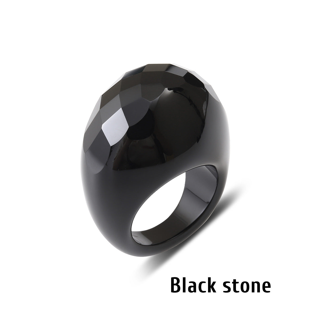 Black stone ring with a faceted geometric face on a white background