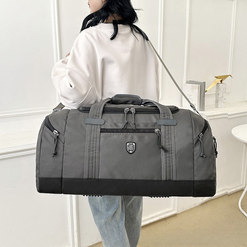 Side view of the Oxford travel duffel bag showing a zip end pocket and the shoulder strap