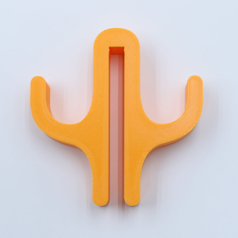 Orange resin double hook with an arm on each side, seen from the front on a light background