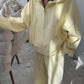 Light Yellow zip-up hoodie and wide leg trousers set worn by a woman, option photo for size L