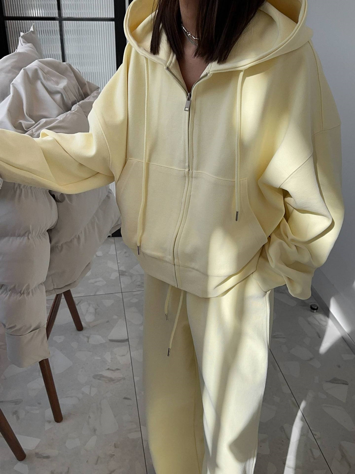 Light Yellow zip-up hoodie and wide leg trousers set worn by a woman, option photo for size L