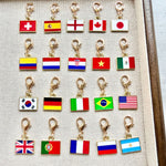 Twenty enamel country flag keychain charms shown with gold tone lobster clasps