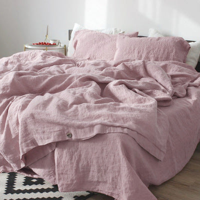 Solid color cotton linen duvet cover with coconut buttons and matching pillowcases on a bed