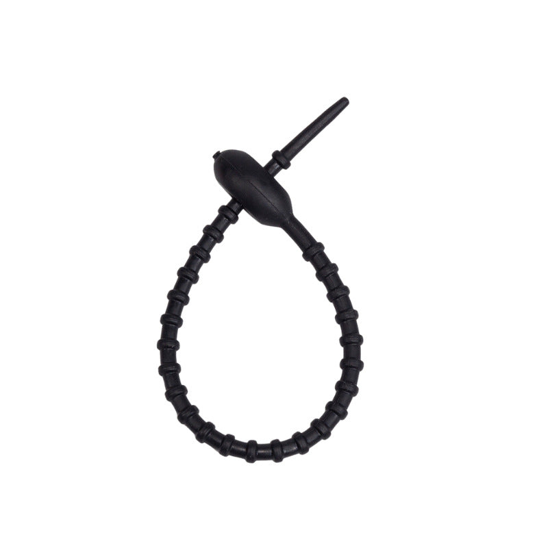 Tadpole silicone tie looped around a wrist to show how flexible the strap is