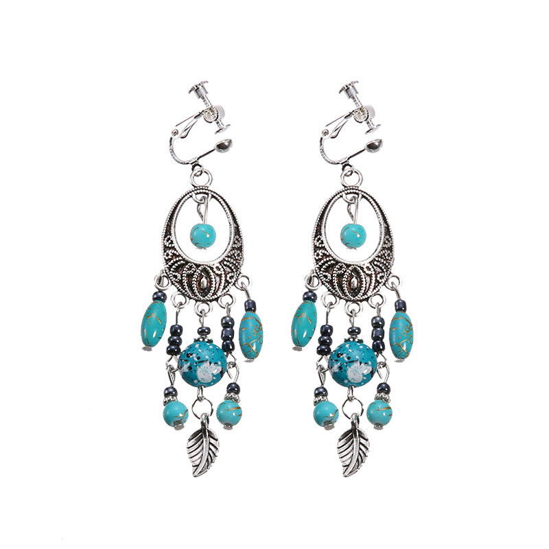 Bohemian vintage clip-on tassel drop earrings on a zinc alloy frame, handmade boho pair on white studio background
