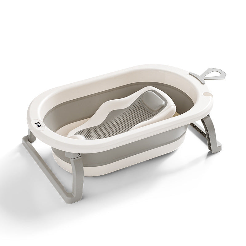 Cream and gray foldable baby bathtub with folding stand and mesh bath rack on a white background