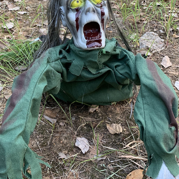 Long haired ghoul crawling Halloween prop with a screaming bloodied face and tattered shroud