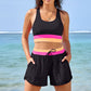 Womens two piece color block swim set worn on the beach, racerback tank top and matching shorts