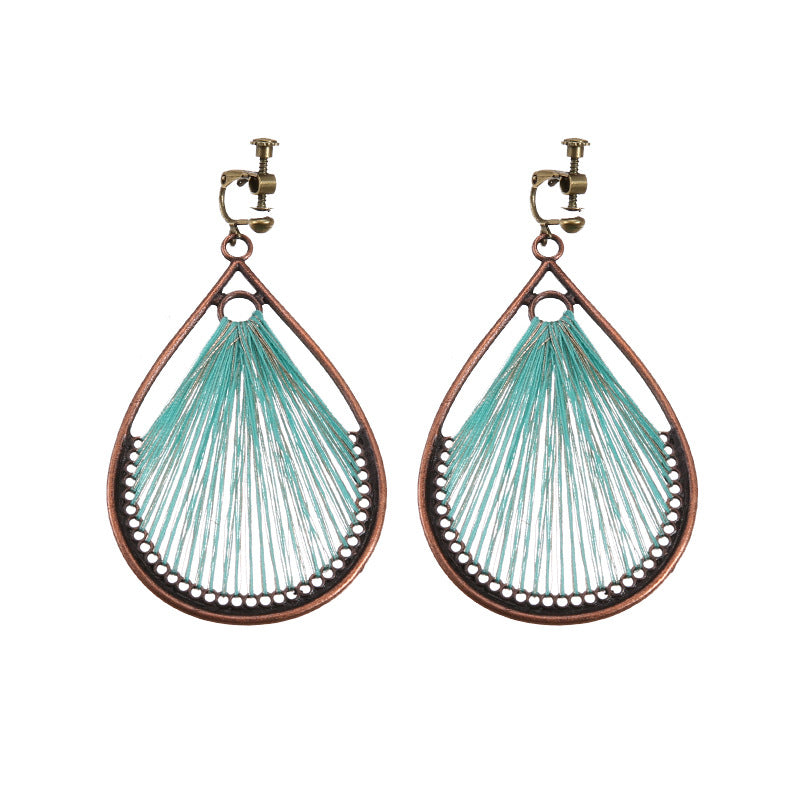 Bohemian tassel and bead clip-on drop earrings, aged tone zinc alloy frame, handmade pair on plain white background