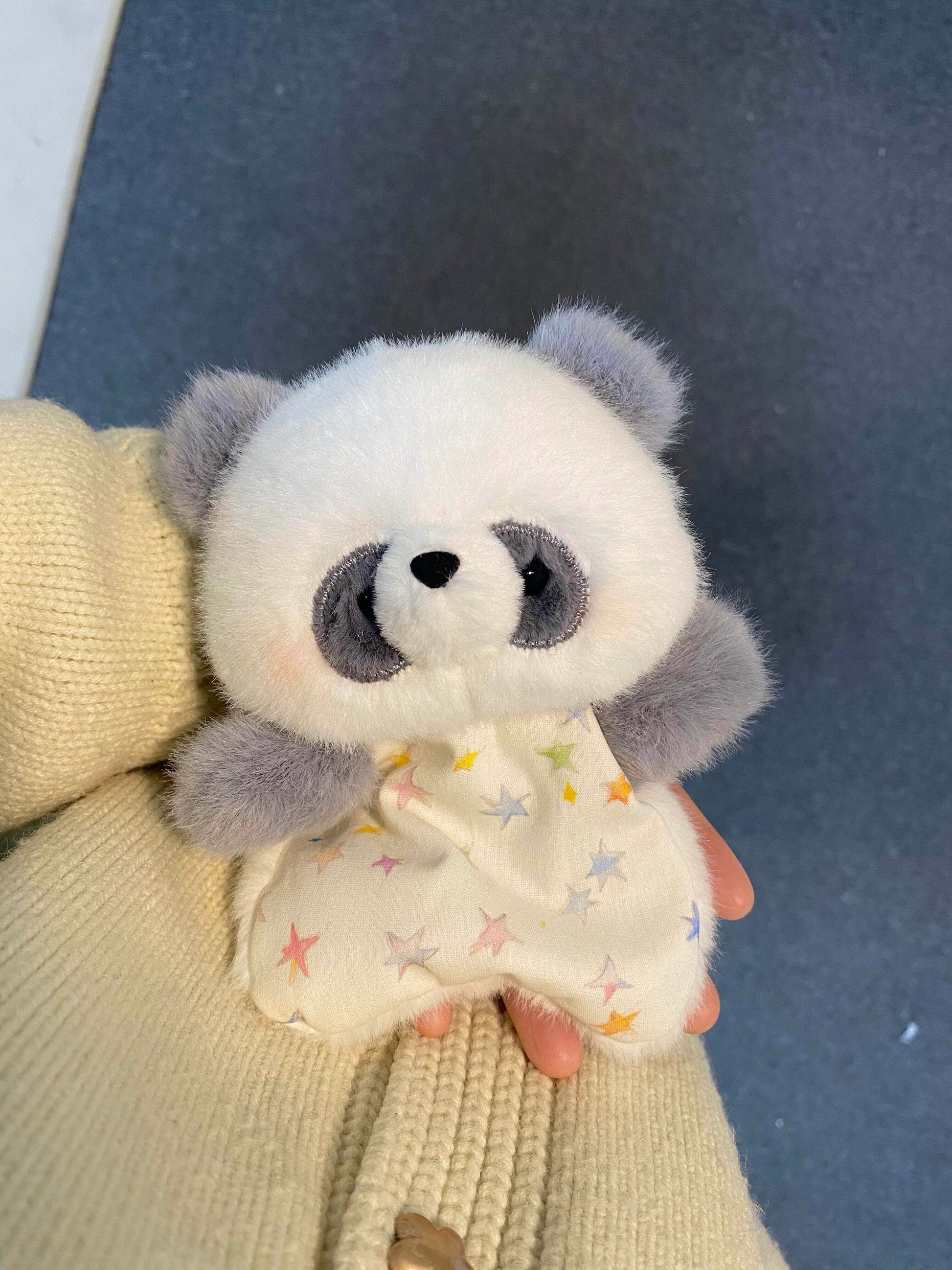 Small squishy bean bag plush animal toy with soft faux fur, held to show its palm size