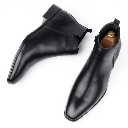 Black smooth ankle boots with a square toe, a side zip and a heel pull tab, a pair seen from above on white