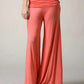 Wide palazzo legs of the coral pants falling to the floor