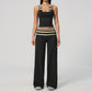 Model in a cropped camisole and wide leg fold over waist pants set, black with cream stripes