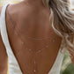 Silver tone crystal back drape necklace on a low back gown