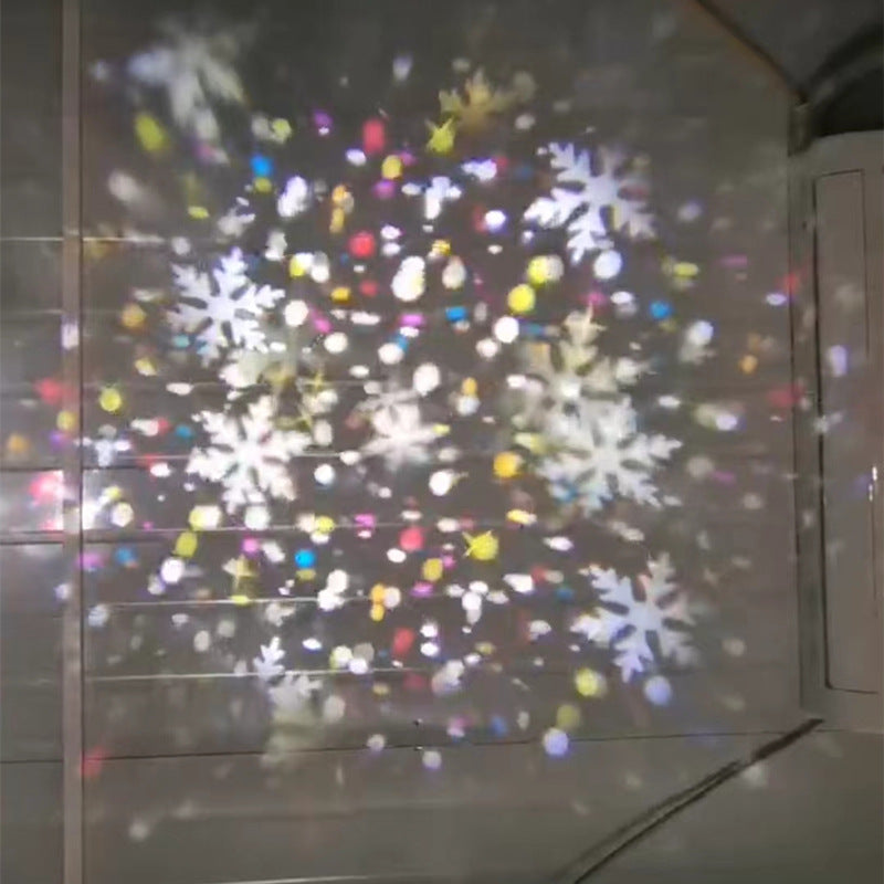 Colored snowflake projection scattered across a dim room wall by the LED pattern projector