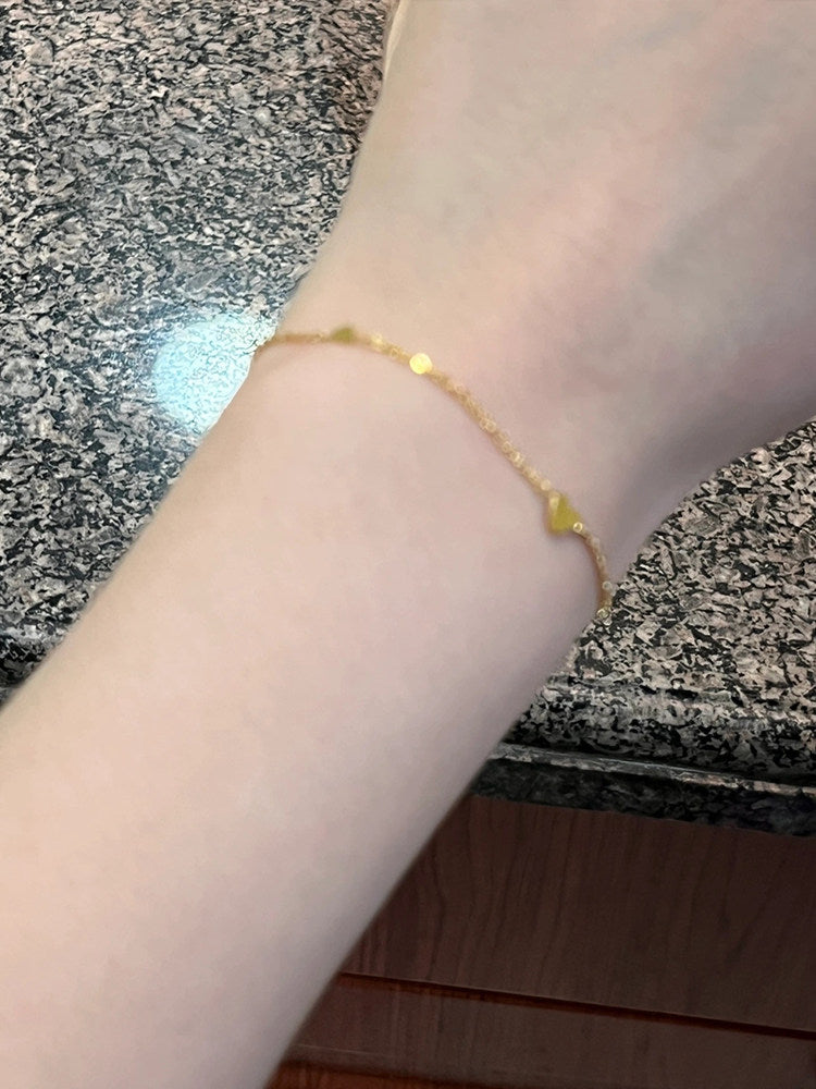 Top down view of the heart bracelet laid flat showing chain length and clasp
