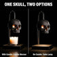 Black skull candle warmer lamp with light glowing out through the eye sockets over a jar candle
