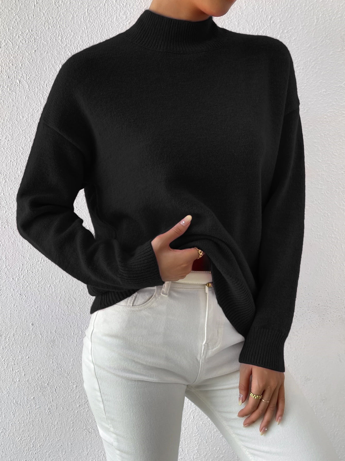 Black half-high neck pullover sweater with long sleeves worn with white trousers, size L variant image