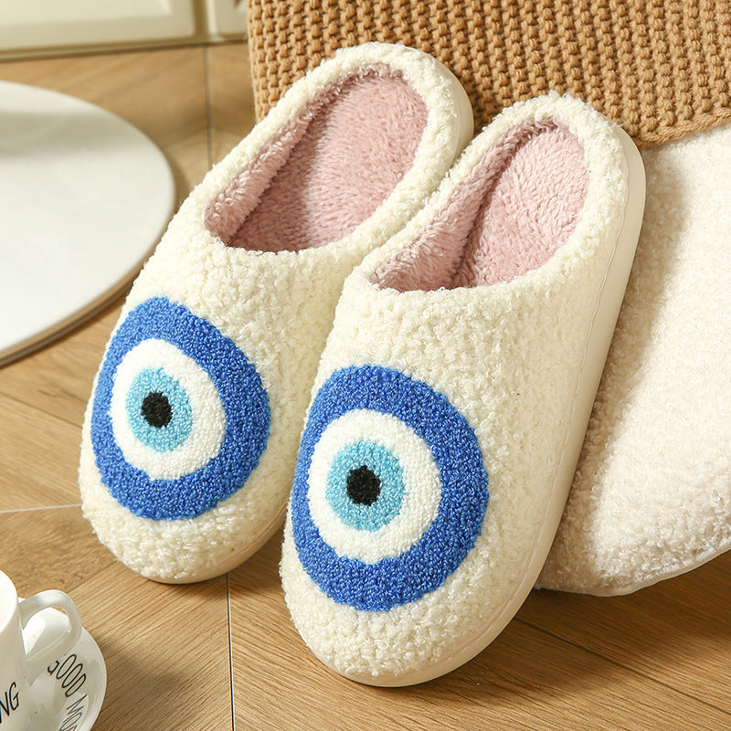 Cream plush slippers with a tufted blue evil eye design, size 40-41 option