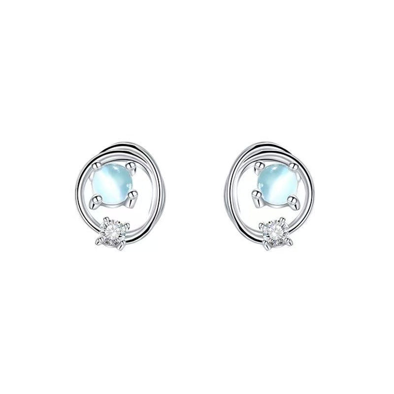 Saturn moonstone-look planet stud earrings in silver tone, opalescent bead ringed by an open orbital loop
