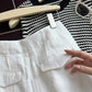 White linen shorts back flap welt pocket detail with striped knit top