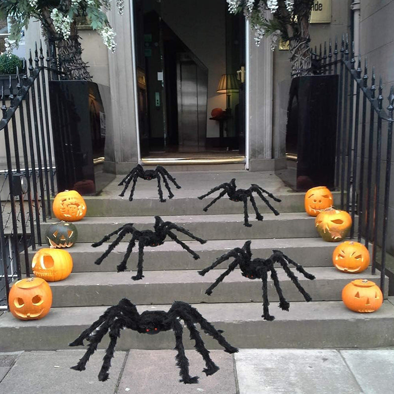 Hairy black Halloween spider prop with red eyes, flocked body and eight posable bendable legs