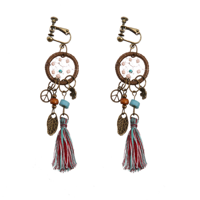Bohemian tassel and bead clip-on drop earrings, aged tone zinc alloy frame, handmade pair on plain white background