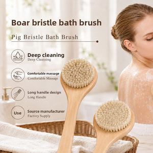 Long handle wooden boar bristle bath brush held to scrub a bather's back in a bright bathroom
