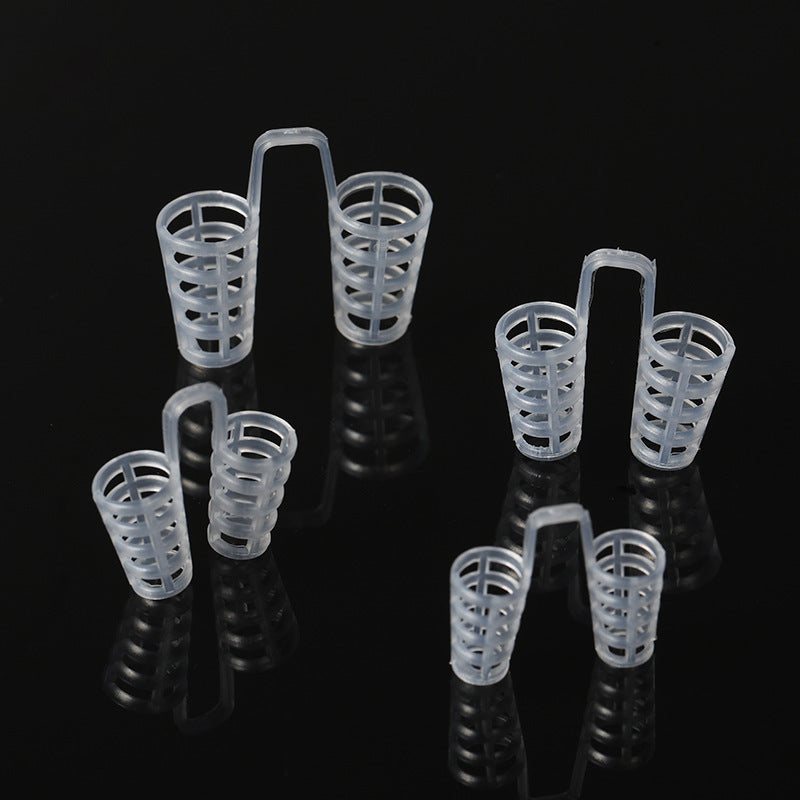 Four clear open lattice nose vents with slotted walls on a black background