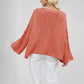 Soft thick knit round neck sweater with a twist cable pattern across the front