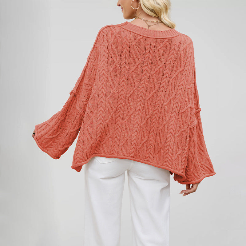Soft thick knit round neck sweater with a twist cable pattern across the front