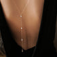 Pearl drop back body chain worn low on an open back
