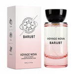 Pink glass Voyage Nova extrait de parfum bottle beside its carton showing lychee rose and patchouli