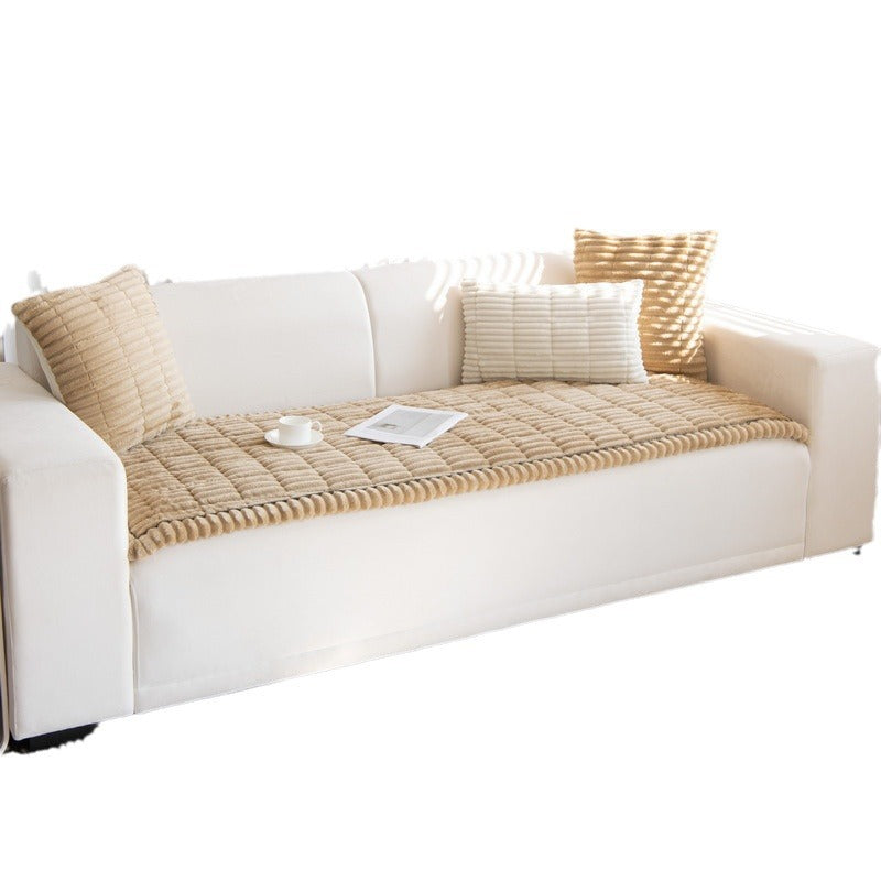 Camel quilted plush sofa cover with a scalloped edge on a white sofa, white background