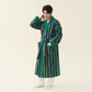 Man in a dark green striped fleece kimono style robe with a belt and patch pockets, hand at his neck