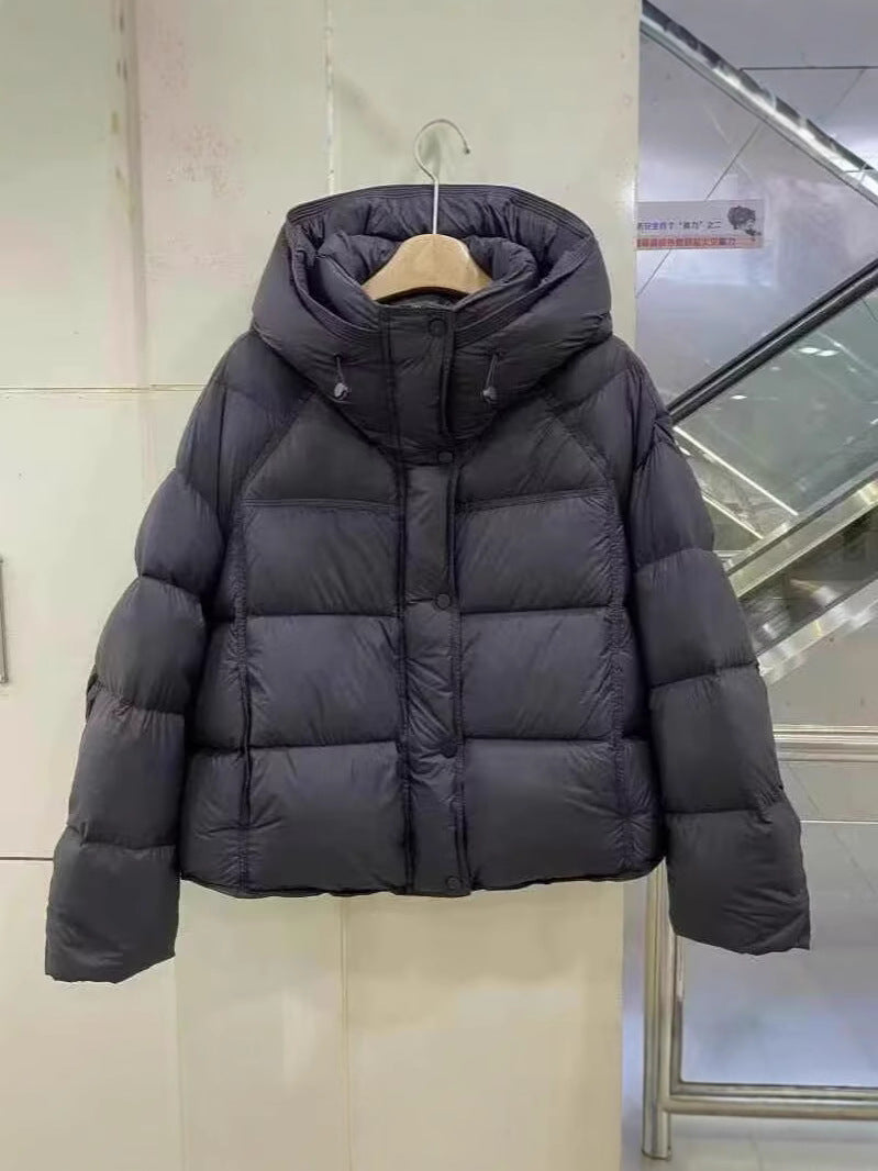 Short hooded down puffer jacket laid flat, wide box quilting and snap button placket down the front