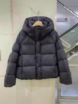 Short hooded down puffer jacket laid flat, wide box quilting and snap button placket down the front