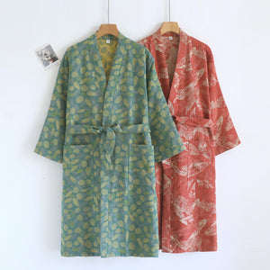 Emerald green and leaf red cotton gauze kimono robes on hangers showing the wrap front and tie belts