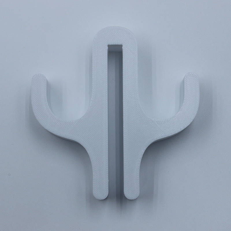 White resin double hook with an arm on each side, seen from the front on a light background