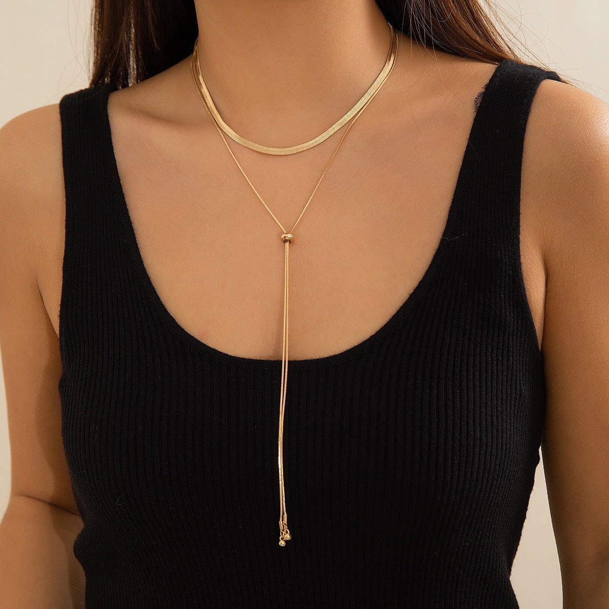 Gold layered snake chain necklace with adjustable bead slider drop on a model