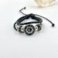 Braided cord charm bracelet close up on the silver tone frame around the charm