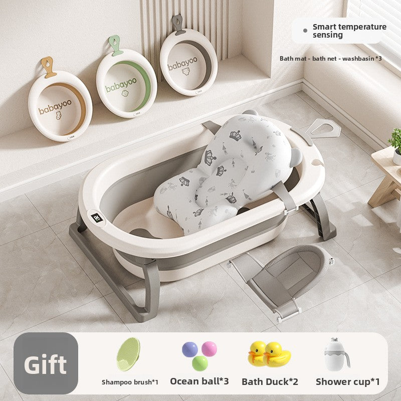 Baby bathtub with printed floating mat, gray bath net lying beside it and three washbasins hung on the wall
