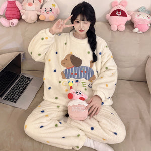 Cream polka dot coral fleece pajama set with a dachshund patch, model on a sofa