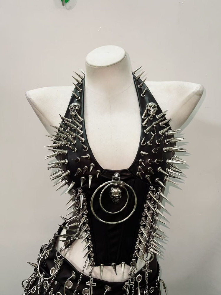 Front view of spiked faux leather punk vest with skull heads at the collar and boned bodice